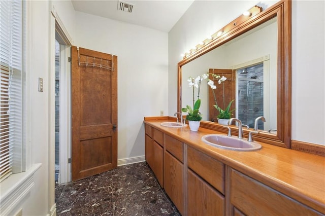 bathroom featuring a sink, visible vents, a shower stall, and double vanity
