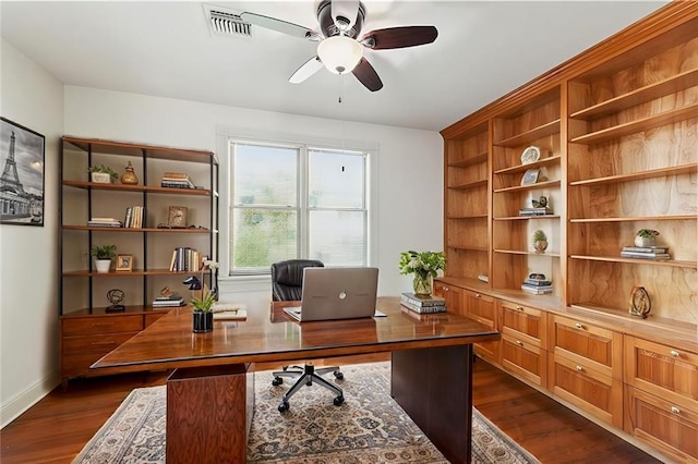 office space featuring baseboards, dark wood-style floors, visible vents, and a ceiling fan