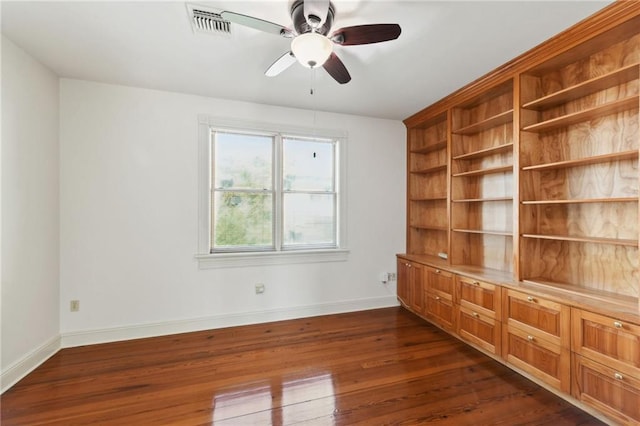 unfurnished room with visible vents, baseboards, a ceiling fan, and dark wood finished floors