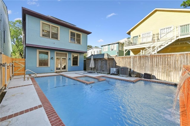 back of property featuring central AC, a fenced backyard, a gate, and a patio area