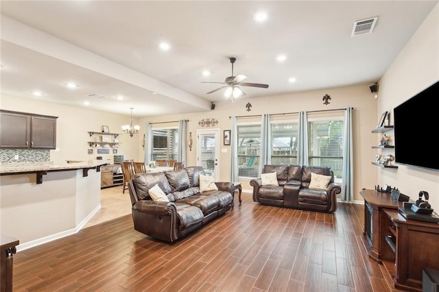 living area featuring visible vents, baseboards, recessed lighting, wood finished floors, and ceiling fan with notable chandelier