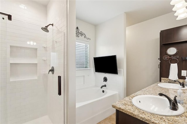 full bathroom with a sink, a bath, a shower stall, and double vanity