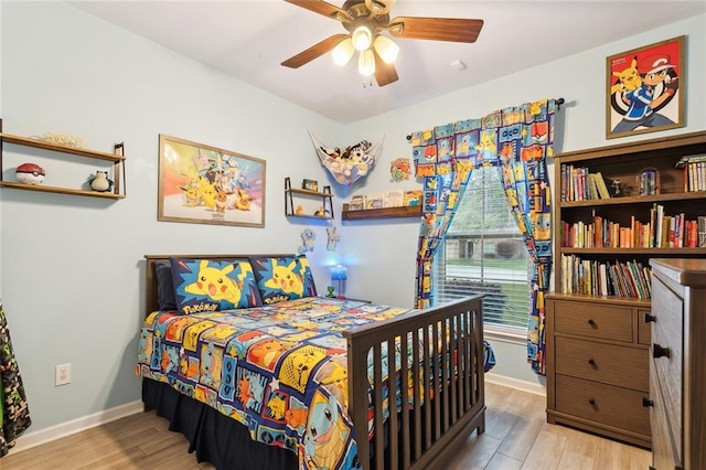 bedroom with ceiling fan, baseboards, and wood finished floors
