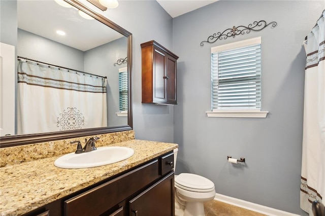 full bathroom featuring tile patterned flooring, toilet, vanity, and baseboards