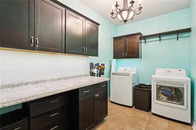 laundry room with cabinet space, washing machine and dryer, and a chandelier