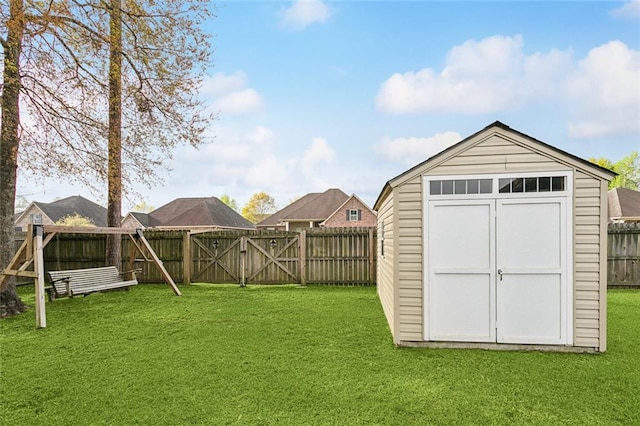 view of shed featuring a fenced backyard and a gate