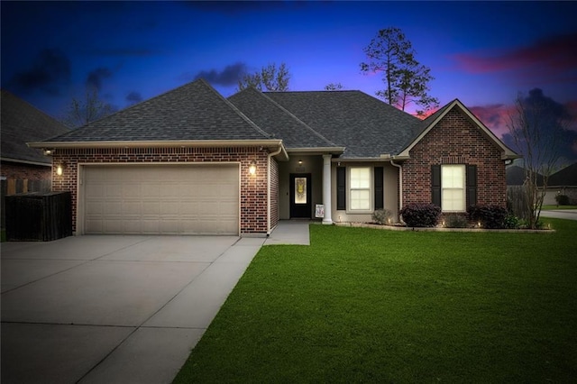 ranch-style home with a garage, brick siding, driveway, and a front lawn