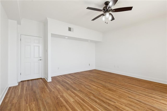 unfurnished room with baseboards, ornamental molding, light wood-style floors, and ceiling fan