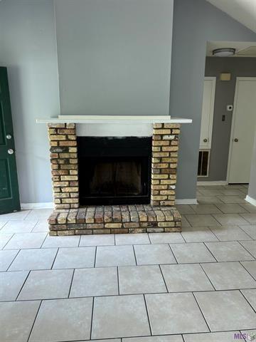 details featuring baseboards and a fireplace