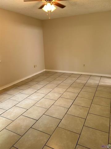 158-160 Beech St, Covington, LA 70443 - unfurnished room with a ceiling fan, baseboards, and light tile patterned floors