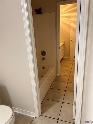 full bathroom featuring tile patterned floors, washtub / shower combination, vanity, and toilet