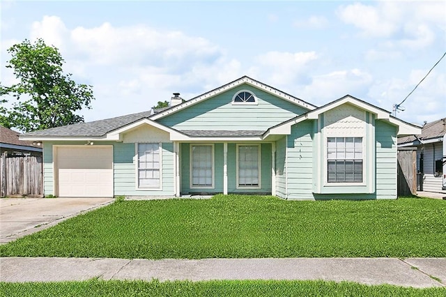 ranch-style house featuring driveway, an attached garage, a front yard, fence, and a shingled roof