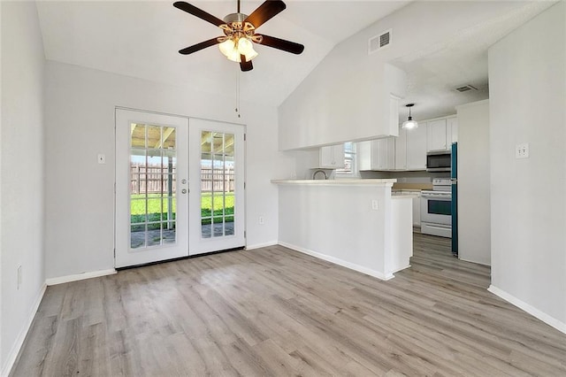 kitchen with stainless steel microwave, french doors, white cabinets, visible vents, and white electric range oven