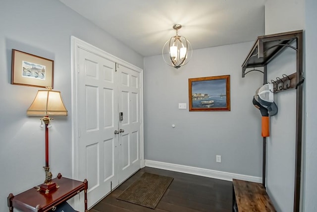 624 Fleurie Dr, Kenner, LA 70065 - entryway featuring a chandelier, dark wood-type flooring, and baseboards