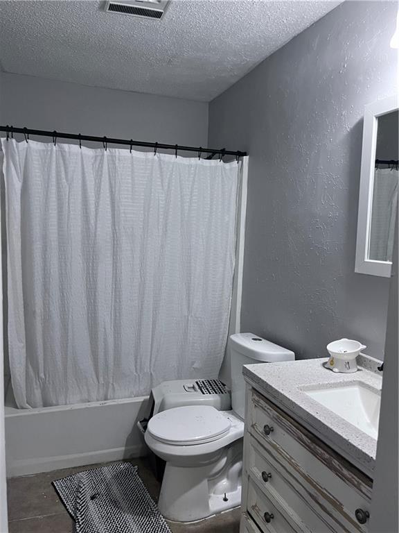1921 Cartier Dr, La Place, LA 70068 - bathroom with a textured ceiling, visible vents, shower / tub combo, vanity, and toilet
