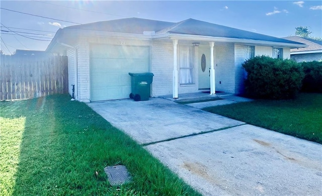 1921 Cartier Dr, La Place, LA 70068 - view of front of home with fence, brick siding, a garage, covered porch, and driveway