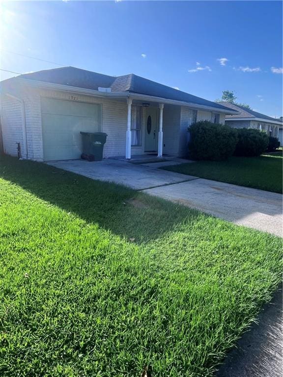 1921 Cartier Dr, La Place, LA 70068 - single story home featuring an attached garage, a front yard, and brick siding