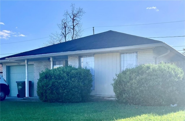 1921 Cartier Dr, La Place, LA 70068 - view of side of home featuring a lawn, brick siding, and a garage