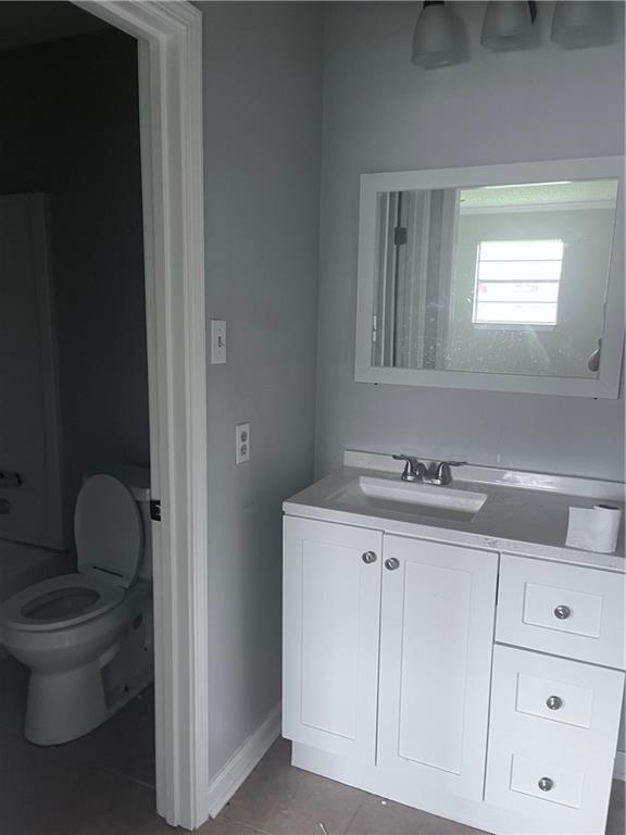 1921 Cartier Dr, La Place, LA 70068 - bathroom featuring toilet, tile patterned floors, baseboards, and vanity