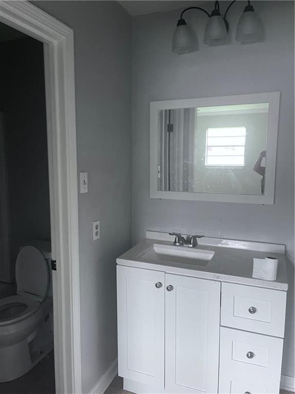 1921 Cartier Dr, La Place, LA 70068 - bathroom with vanity, baseboards, and toilet
