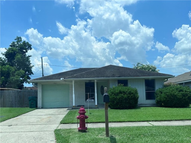 1921 Cartier Dr, La Place, LA 70068 - ranch-style home featuring an attached garage, driveway, covered porch, brick siding, and a shingled roof