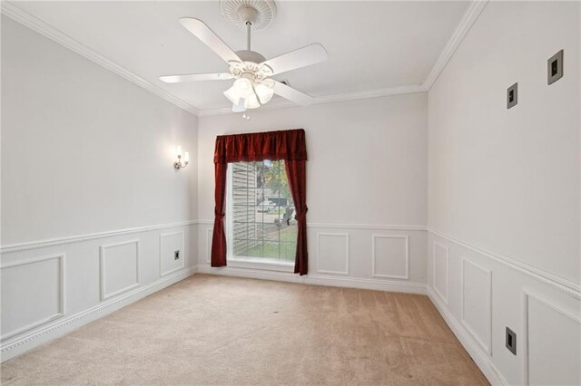1091 Marina Dr, Slidell, LA 70458 - empty room featuring a decorative wall, light colored carpet, ornamental molding, and ceiling fan