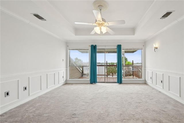 1091 Marina Dr, Slidell, LA 70458 - unfurnished room featuring carpet flooring, visible vents, and a tray ceiling