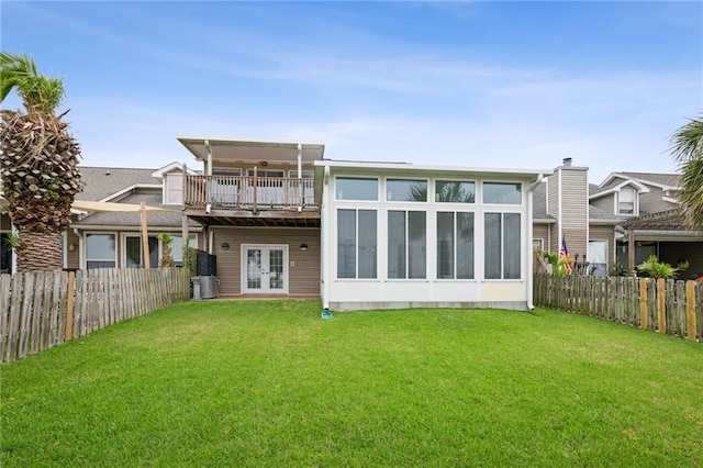 1091 Marina Dr, Slidell, LA 70458 - back of property with french doors, a fenced backyard, and a lawn