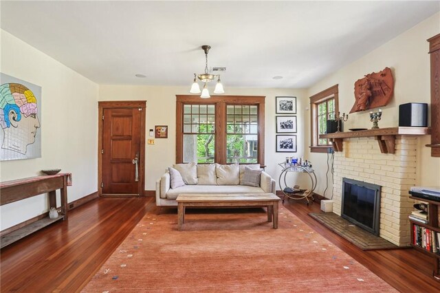 2227 Wirth Pl, New Orleans, LA 70115 - living room with a chandelier, wood finished floors, baseboards, and a wealth of natural light