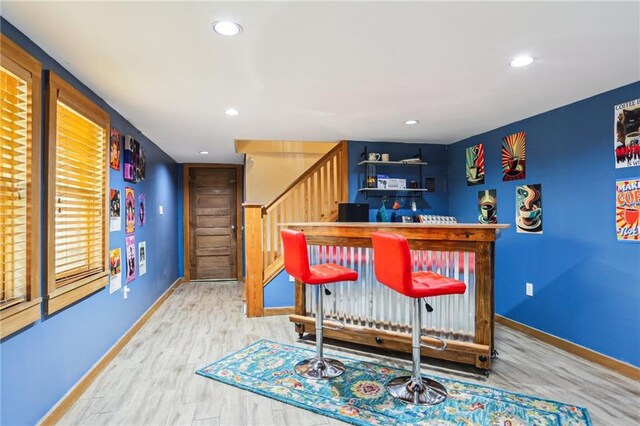 2227 Wirth Pl, New Orleans, LA 70115 - bar with stairs, baseboards, a dry bar, and wood finished floors