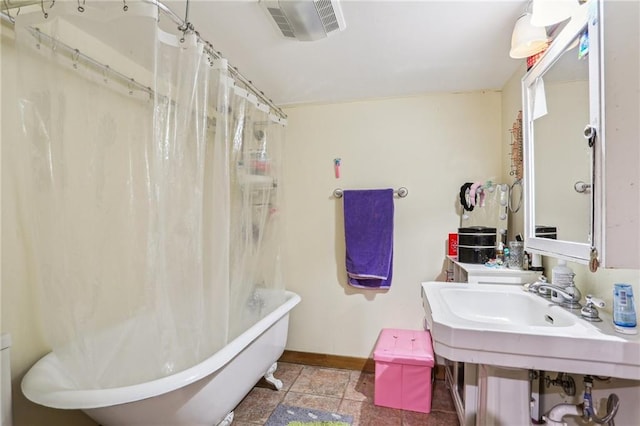 2227 Wirth Pl, New Orleans, LA 70115 - full bath with visible vents, baseboards, and tile patterned floors