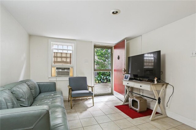 2227 Wirth Pl, New Orleans, LA 70115 - living area featuring light tile patterned floors, cooling unit, and baseboards