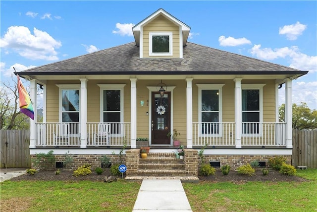 85 W Claiborne Sq, Chalmette, LA 70043 - view of front of house with a porch, a shingled roof, crawl space, and fence