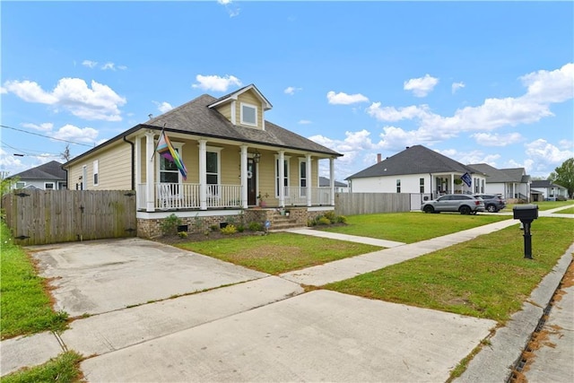 85 W Claiborne Sq, Chalmette, LA 70043 - bungalow-style house featuring a porch, fence, and a front lawn