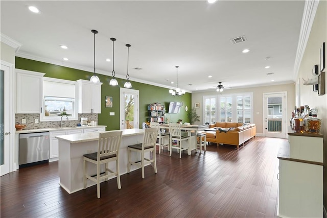 85 W Claiborne Sq, Chalmette, LA 70043 - kitchen featuring stainless steel dishwasher, tasteful backsplash, visible vents, and dark wood finished floors