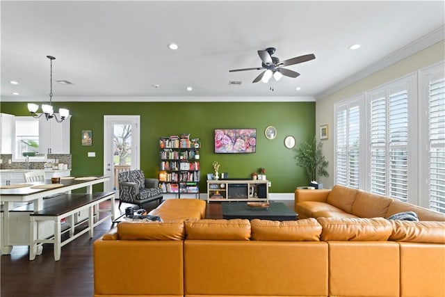 85 W Claiborne Sq, Chalmette, LA 70043 - living room with visible vents, ornamental molding, dark wood-style floors, recessed lighting, and ceiling fan with notable chandelier