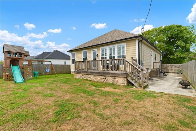 85 W Claiborne Sq, Chalmette, LA 70043 - rear view of property featuring a fenced backyard, a playground, a patio, and a lawn