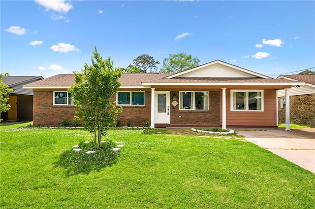 ranch-style home with a front yard and brick siding