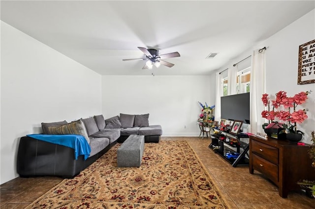 tiled living area featuring baseboards, a ceiling fan, and visible vents