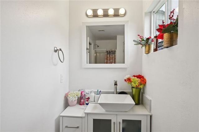 full bath featuring vanity, visible vents, and curtained shower
