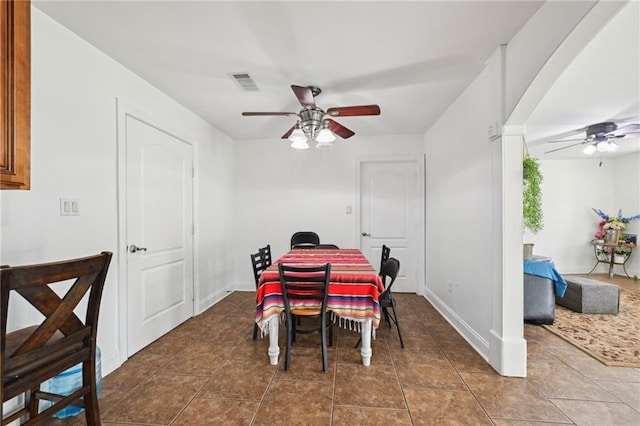 dining room with tile patterned floors, ceiling fan, baseboards, and visible vents