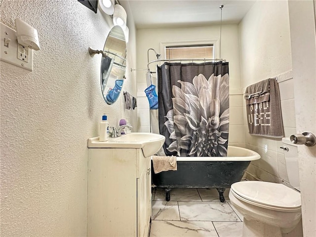 165355 Treasure St, New Orleans, LA 70119 - bathroom featuring marble look tiles, vanity, a textured wall, and toilet