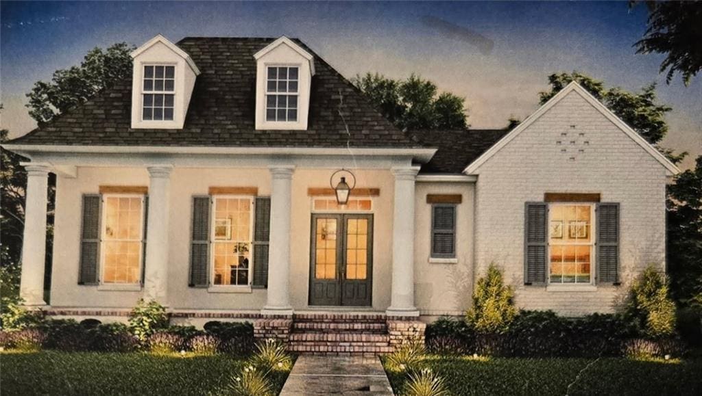 view of front facade featuring french doors, roof with shingles, and brick siding