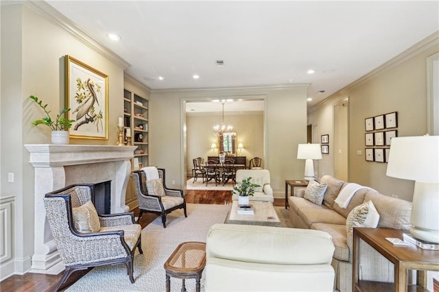 519 Homestead Ave, Metairie, LA 70005 - living room featuring built in features, ornamental molding, a chandelier, recessed lighting, and wood finished floors