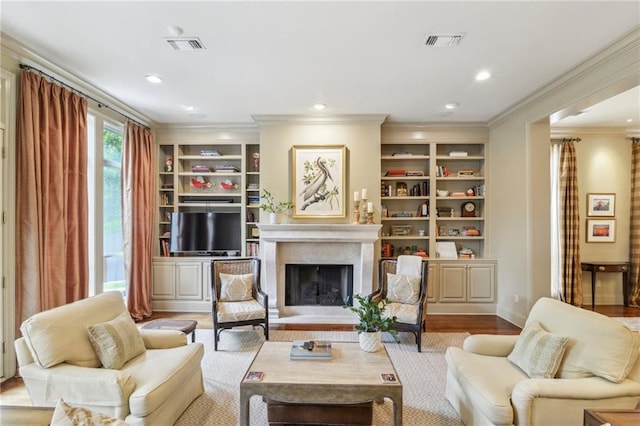 519 Homestead Ave, Metairie, LA 70005 - living area with recessed lighting, crown molding, a fireplace with raised hearth, visible vents, and wood finished floors