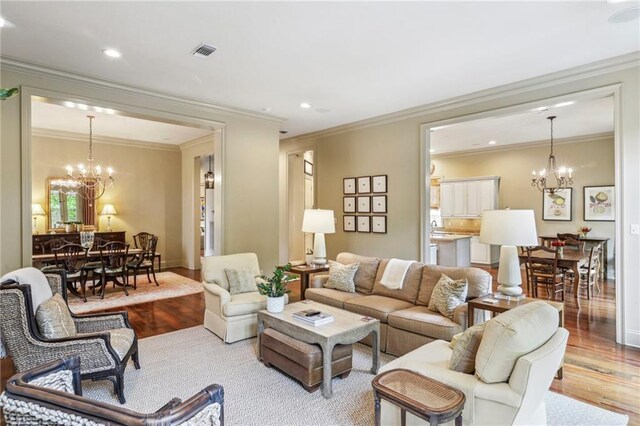 519 Homestead Ave, Metairie, LA 70005 - living area featuring visible vents, baseboards, a notable chandelier, recessed lighting, and wood finished floors