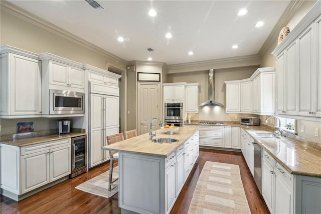 519 Homestead Ave, Metairie, LA 70005 - kitchen featuring a sink, wine cooler, wall chimney exhaust hood, and built in appliances