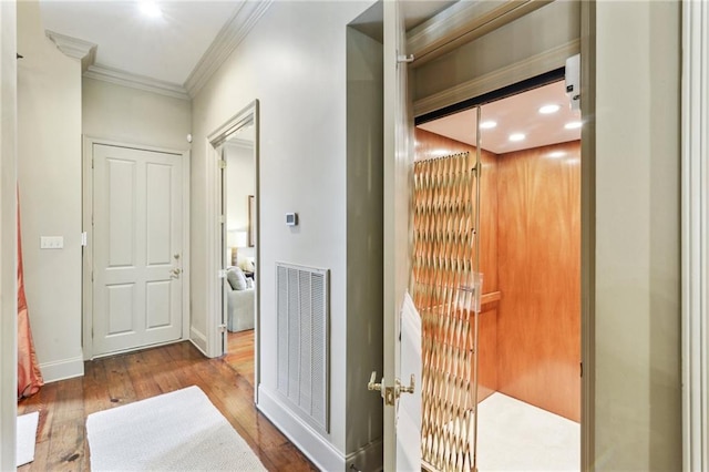 519 Homestead Ave, Metairie, LA 70005 - hallway with crown molding, visible vents, wood finished floors, baseboards, and elevator