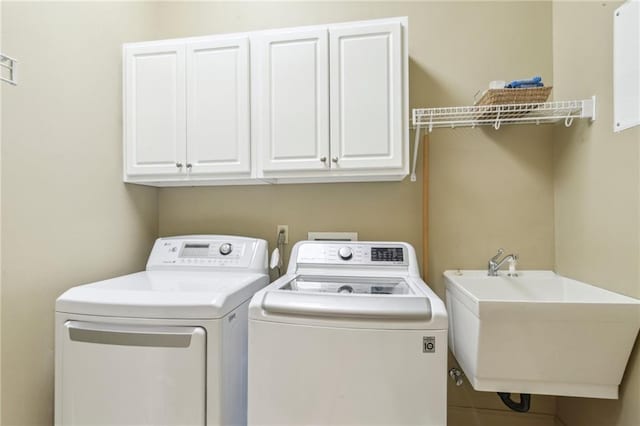 519 Homestead Ave, Metairie, LA 70005 - laundry area featuring washer and dryer, a sink, and cabinet space