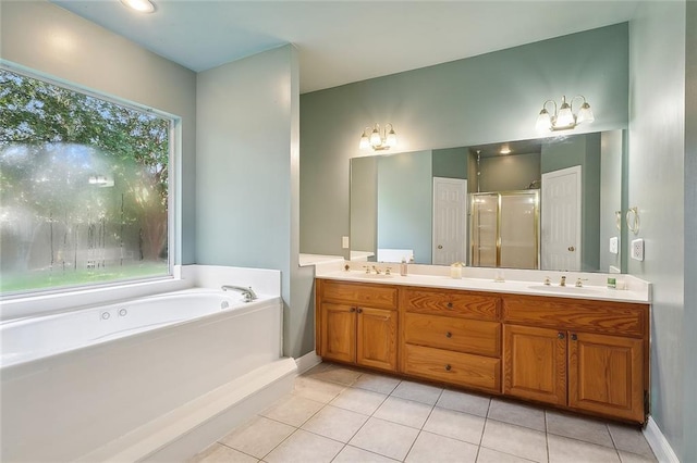 full bathroom featuring tile patterned floors, plenty of natural light, a bath, and a sink